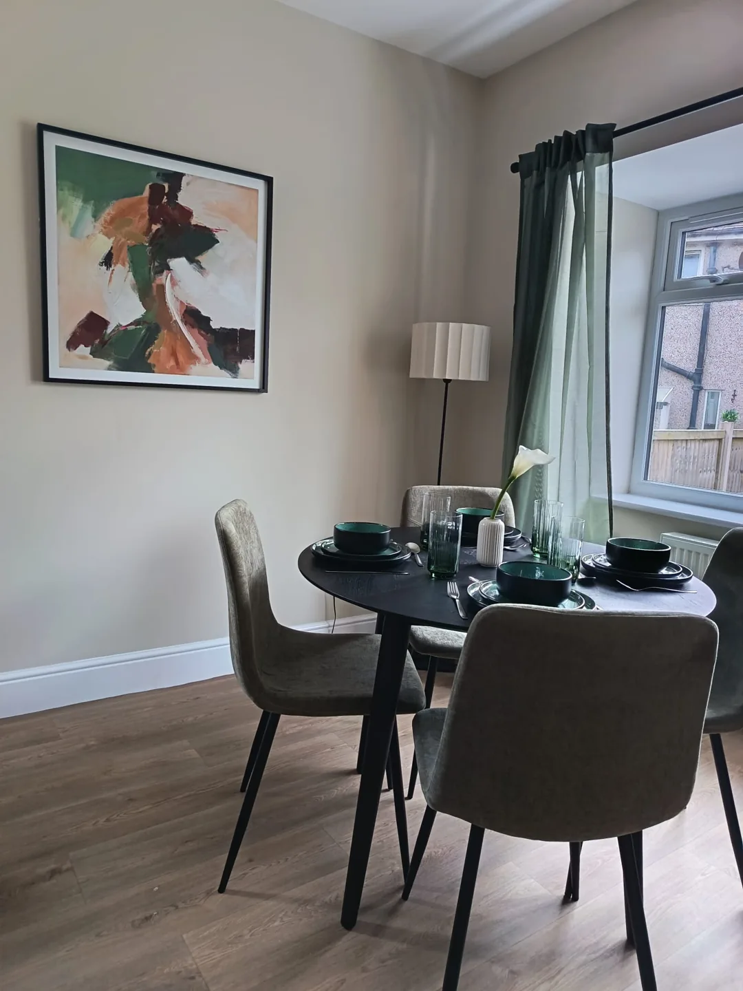 Styled dining table with green ceramic place settings